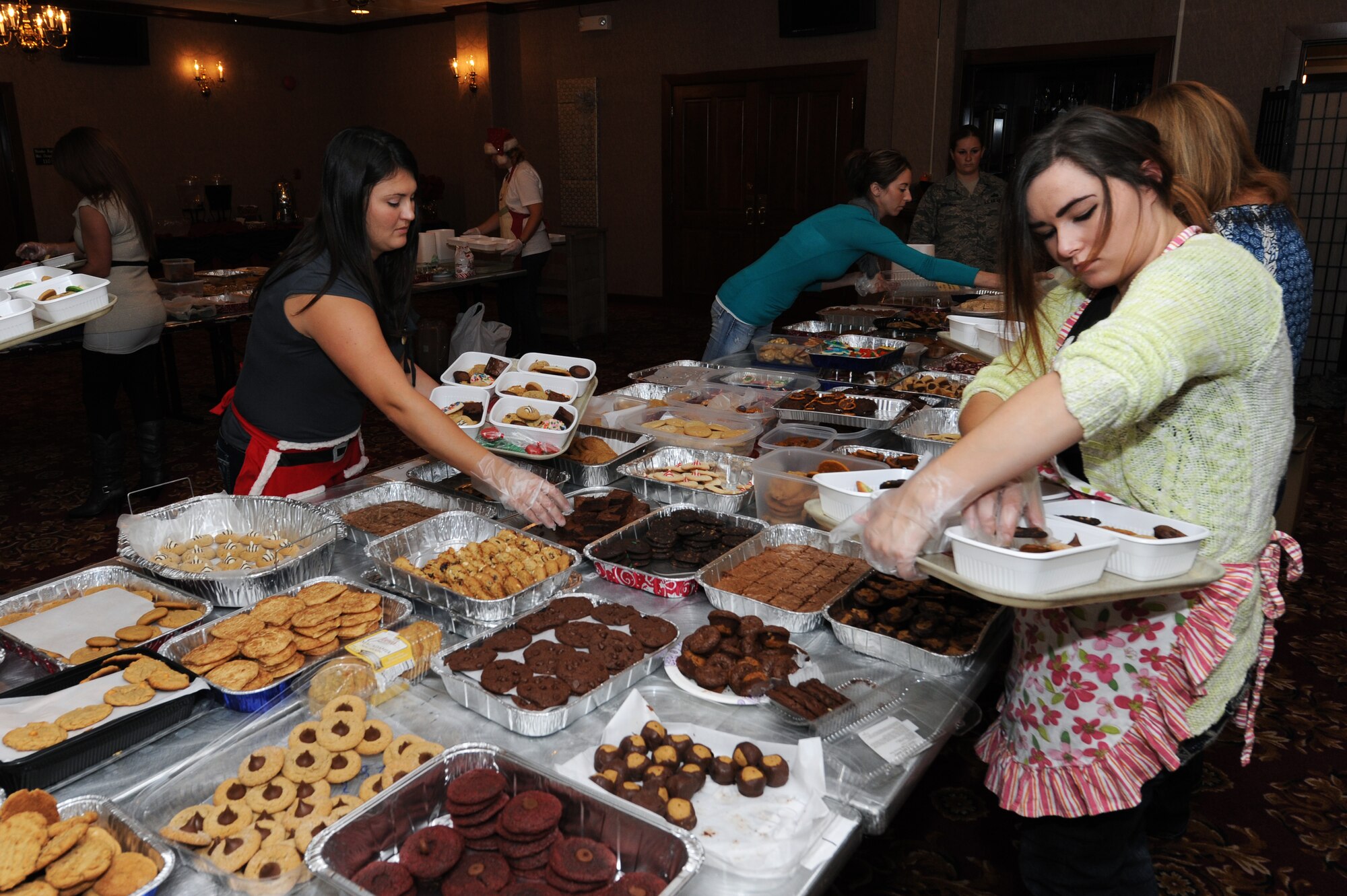 Volunteers pack cookies into individual boxes during the holiday cookie drive on Kadena Air Base, Japan, Dec. 9, 2014. The holiday cookie drive is an annual event coordinated entirely by volunteers. Each year, thousands of cookies are donated and packaged for delivery to the single service members living in dormitories on Kadena. (U.S. Air Force photo by Airman 1st Class Zade C. Vadnais/Released)