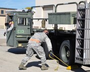 Staff Sgt. Andrew Anderson, 73rd Aerial Port Squadron ramp agent and driver, waits for Staff Sgt. William Balansay, also a 73 APS ramp agent, to pull the chalk block from behind the wheel of a Tunner 60k aircraft cargo loader/transporter at Naval Air Station Fort Worth Joint Reserve Base, Texas, Dec. 6, 2014. The machine, borrowed from the 502nd Logistics Readiness Squadron, Joint Base San Antonio, Texas, and delivered on a 433rd Airlift Wing C-5, gave crucial operational training to nearly 30 aerial port Airmen. (U.S. Air Force photo by Master Sgt. Julie Briden-Garcia)
