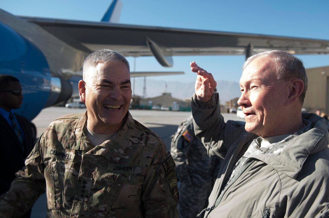 U.S. Army Gen. Martin E. Dempsey, chairman of the Joint Chiefs of Staff, right, speaks with Army Gen. John F. Campbell, the commander of the International Security Assistance Force and U.S. Forces Afghanistan, on Bagram Airfield, Afghanistan, Dec. 8, 2014. Dempsey  hosted a USO show during his visit.