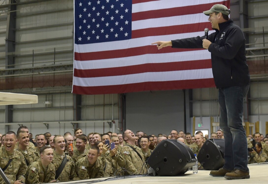 Actor and comedian Rob Riggle performs during a USO show on Bagram Airfield, Afghanistan, Dec. 8, 2014.  