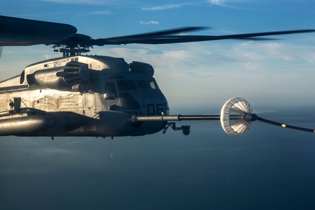 A CH-53E Super Stallion helicopter receives fuel during an aerial refueling exercise on Marine Corps Air Station Cherry Point, N.C., Dec. 3, 2014. The helicopter crew is assigned to Marine Heavy Helicopter Squadron 366.