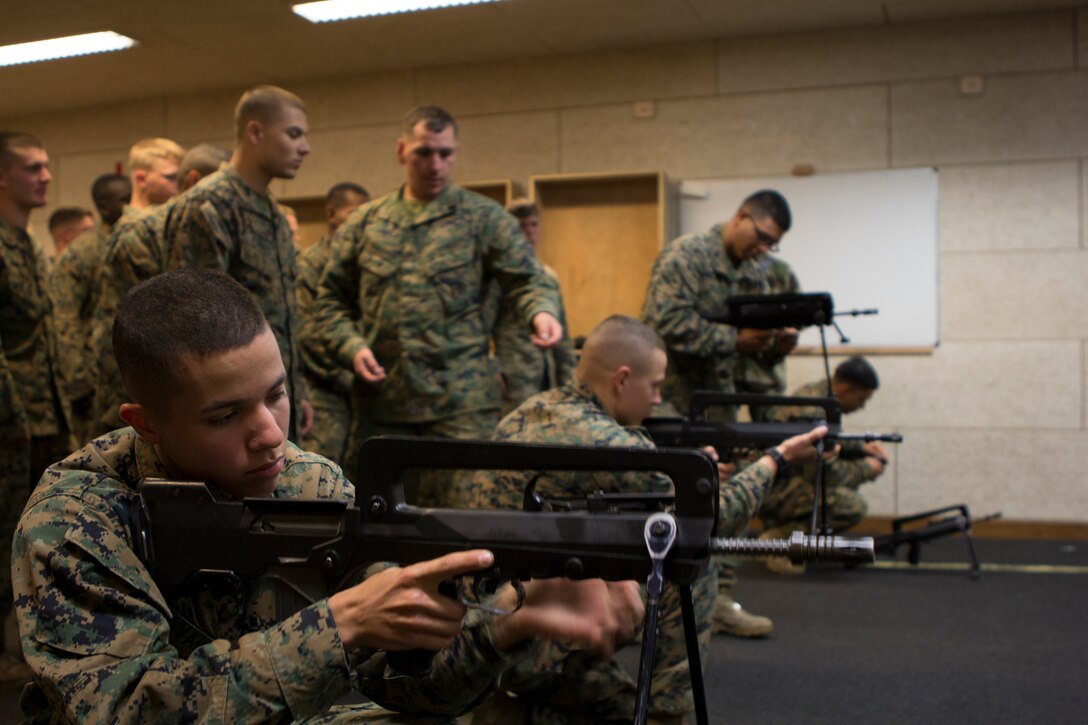 U.S. Marine with SPMAGTF Crisis Response – Africa practice weapons safety handling with the French FAMAS rifle at the National Gendarmerie Training Center in St. Astier, France, Dec. 1, 2014.  The Marines were conducting crowd and riot control training with the French Gendarmerie, allowing the Marines to gain greater knowledge of non-lethal tactics, techniques and procedures while enhancing interoperability with the French Gendarmerie and strengthening the U.S. partnership with France.  (U.S. Marine Corps photo by Cpl. Jeraco Jenkins/Released)