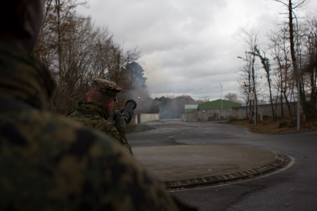 U.S. Marine Lance Cpl. Chase M. Graves grenadier with SPMAGTF Crisis Response – Africa, shoots a tear gas canister from a Cougar grenade launcher at the National Gendarmerie Training Center in St. Astier, France, Dec. 1, 2014.  The Marines were conducting crowd and riot control training with the French Gendarmerie, allowing the Marines to gain greater knowledge of non-lethal tactics, techniques and procedures while enhancing interoperability with the French Gendarmerie and strengthening the U.S. partnership with France.  (U.S. Marine Corps photo by Cpl. Jeraco Jenkins/Released).