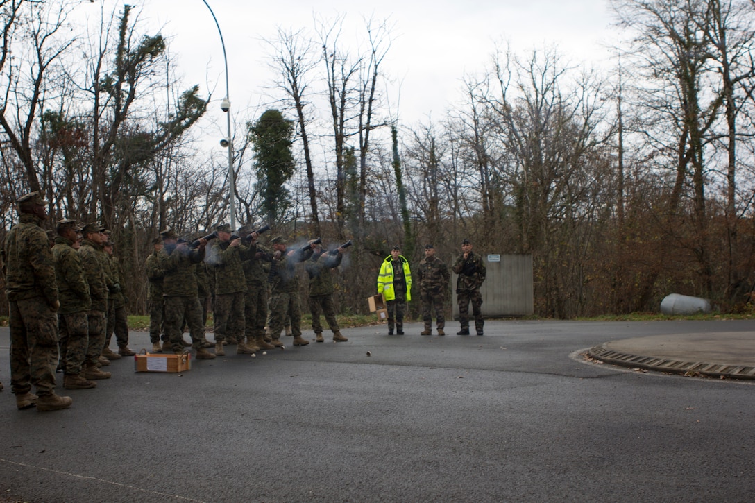 U.S. Marines with SPMAGTF Crisis Response – Africa, shoot tear gas canister from a Cougar grenade launcher while Crowd and Riot Control Unit instructors with Mobile Gendarmeries Armored Group watch on (Centre National D’ Etrainement Des Forces De Gendarmerie) National Center for Training of Police Forces of France, St. Astier, France, Dec 1, 2014. SPMAGTF-CR-AF is a highly mobile crisis response force that conducts missions to protect U.S. personnel, property, and interests in the U.S. Africa Command area of responsibility. (U.S. Marine Corps photo by Cpl. Jeraco Jenkins/Released).