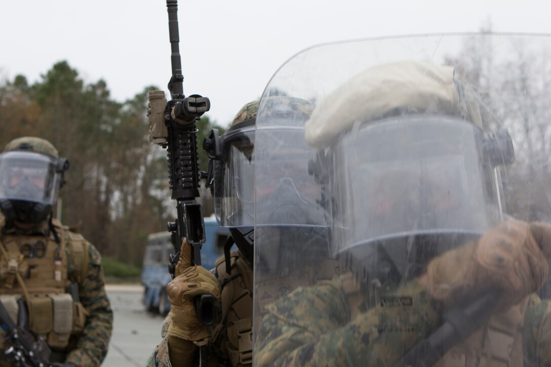 U.S. Marines with SPMAGTF Crisis Response – Africa use a shield to protect them from projectiles being thrown by riot role-players during crowd and riot control training at the National Gendarmerie Training Center in St. Astier, France, Dec. 2, 2014.  The exercise, which was conducted with the French Gendarmerie, allowed the Marines to gain greater knowledge of non-lethal tactics, techniques and procedures while enhancing interoperability with the French Gendarmerie and strengthening the U.S. partnership with France.  (U.S. Marine Corps photo by Cpl. Jeraco Jenkins/Released)