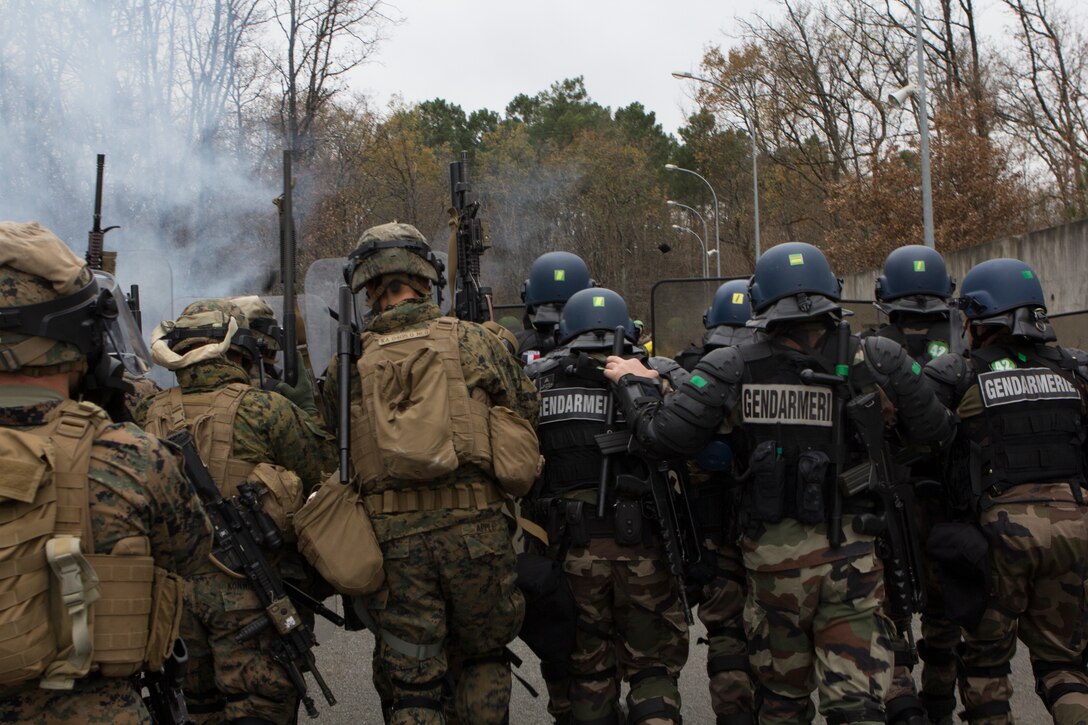 U.S. Marines with SPMAGTF Crisis Response – Africa and Police with Mobile Gendarmeries Armored Group and practice crowd and riot control techniques on National Center for Training of Police Forces of France, St. Astier, France, Dec 2, 2014.  The training enhanced mission readiness and help build relationships between the two militaries. (U.S. Marine Corps photo by Cpl Jeraco Jenkins/Released).