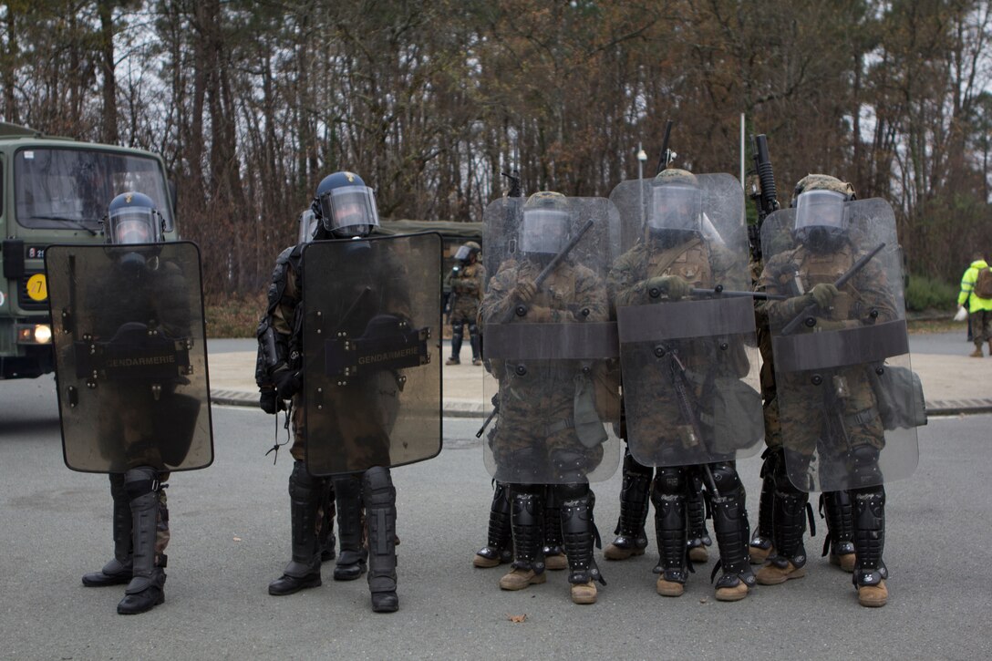 U.S. Marines with SPMAGTF Crisis Response – Africa and Police with Mobile Gendarmeries Armored Group practice crowd and riot control techniques on  National Center for Training of Police Forces of France, St. Astier, France, Dec. 2, 2014.  The training enhanced mission readiness and help build relationships between the two militaries. (U.S. Marine Corps photo by Cpl Jeraco Jenkins/Released).