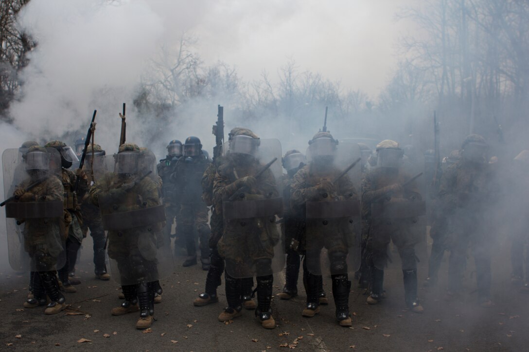 U.S. Marines with SPMAGTF Crisis Response – Africa and French gendarmes with Mobile Gendarmeries Armored Group work together to control a mock riot caused by role-players, while training in crowd and riot control techniques at the National Gendarmerie Training Center in St. Astier, France, Dec. 2, 2014. The exercise allowed the Marines to gain greater knowledge of non-lethal tactics, techniques and procedures while enhancing interoperability with the French Gendarmerie and strengthening the U.S. partnership with France. (U.S. Marine Corps photo by Cpl Jeraco Jenkins/Released).