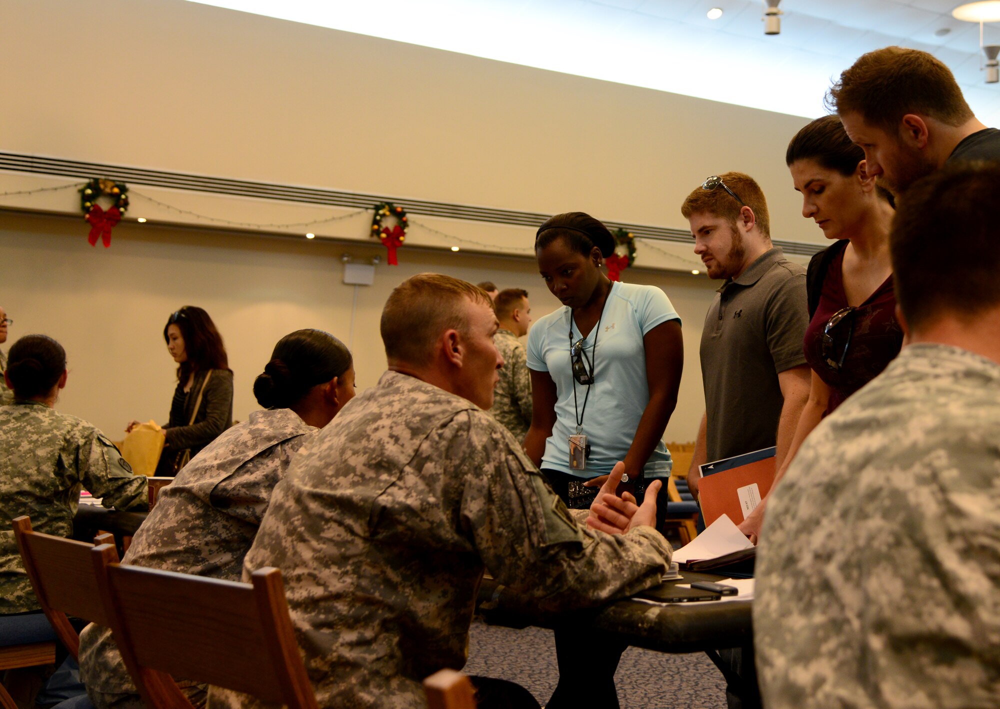 Participants of a Noncombatant Evacuation Operations exercise process through the evacuation center, Dec. 6, 2014, at Camp As Sayliyah, Qatar. In the event of an evacuation of military dependents and non-essential DoD employees, the U.S. Army is tasked with its planning and execution. These types of exercises are used as a tool to assess and validate the procedures by which the Army fulfills that obligation. (U.S. Air Force photo by Senior Airman Kia Atkins)