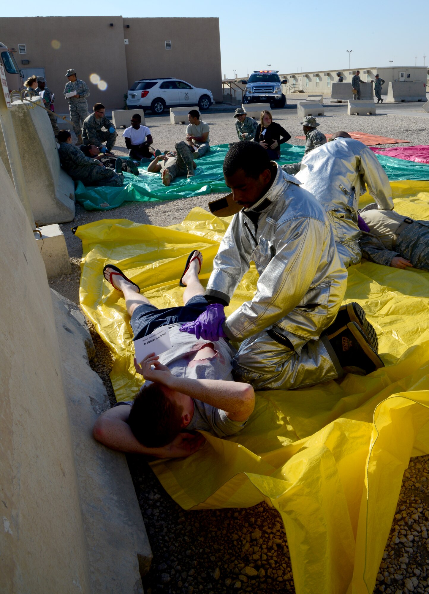 First responders provide initial treatment to simulated victims during an active shooter exercise, Dec. 10, 2014, at Al Udeid Air Base, Qatar. The active shooter exercise scenario tested emergency responders’ ability to respond to a shooter and the base’s ability to handle the aftermath of a violent incident. (U.S. Air Force photo by Senior Airman Kia Atkins)