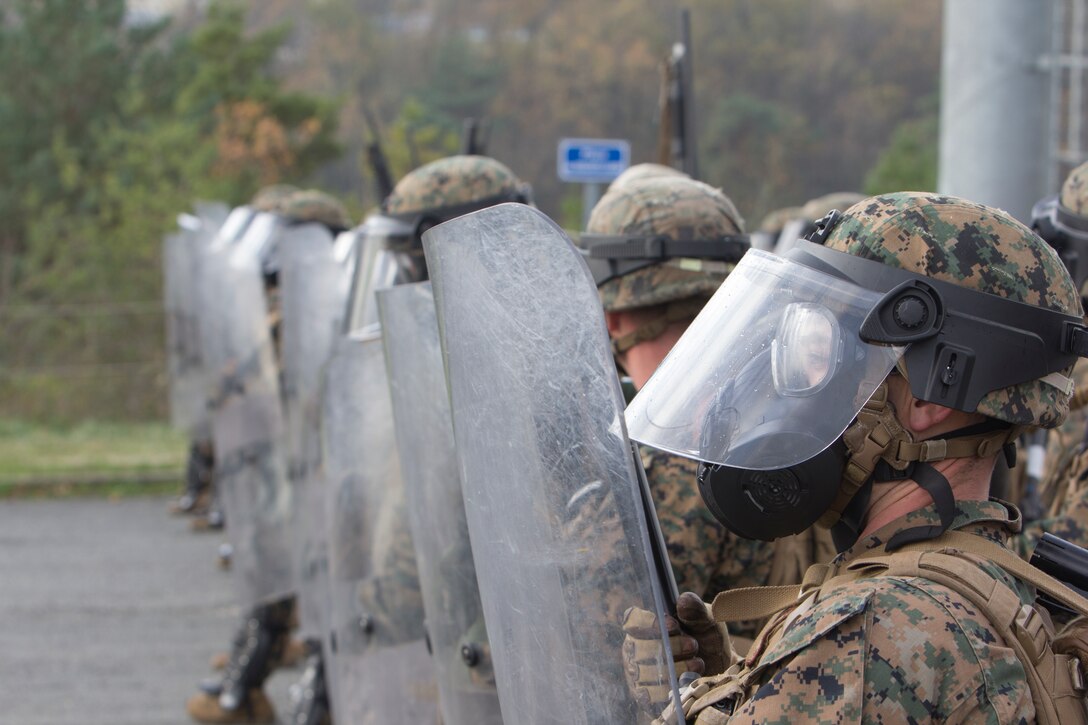 U.S. Marines with SPMAGTF Crisis Response – Africa march together using shields to protect themselves from projectiles being thrown by role-playing rioters during training in crowd and riot control techniques at the National Gendarmerie Training Center in St. Astier, France, Dec. 3, 2014. The exercise allowed the Marines to gain greater knowledge of non-lethal tactics, techniques and procedures while enhancing interoperability with the French Gendarmerie and strengthening the U.S. partnership with France. (U.S. Marine Corps photo by Cpl Jeraco Jenkins/Released)