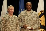 Brig. Gen. Nathaniel S. Reddicks, assistant adjutant general-air for the California National Guard), right, accepts the National Guard Bureau Excellence in Diversity award from Gen. Frank J. Grass, chief of the National Guard Bureau, on behalf of the CNG’s 129th Rescue Wing on Dec. 10, 2014, during the National Guard Diversity Conference in Savannah, Georgia. The award is presented each year to one Air Force unit and one Army unit as well as multiple individuals who made significant contributions to diversity in the National Guard.
