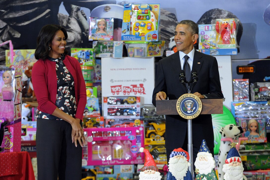 First Lady Michelle Obama reacts to a joke by her husband President Barack Obama during an event supporting the U.S. Marine Corps Reserve Toys for Tots Program at Joint Base Anacostia-Bolling in Washington, D.C. Dec. 10, 2014. The president exaggerated his reaction for children in the audience. 