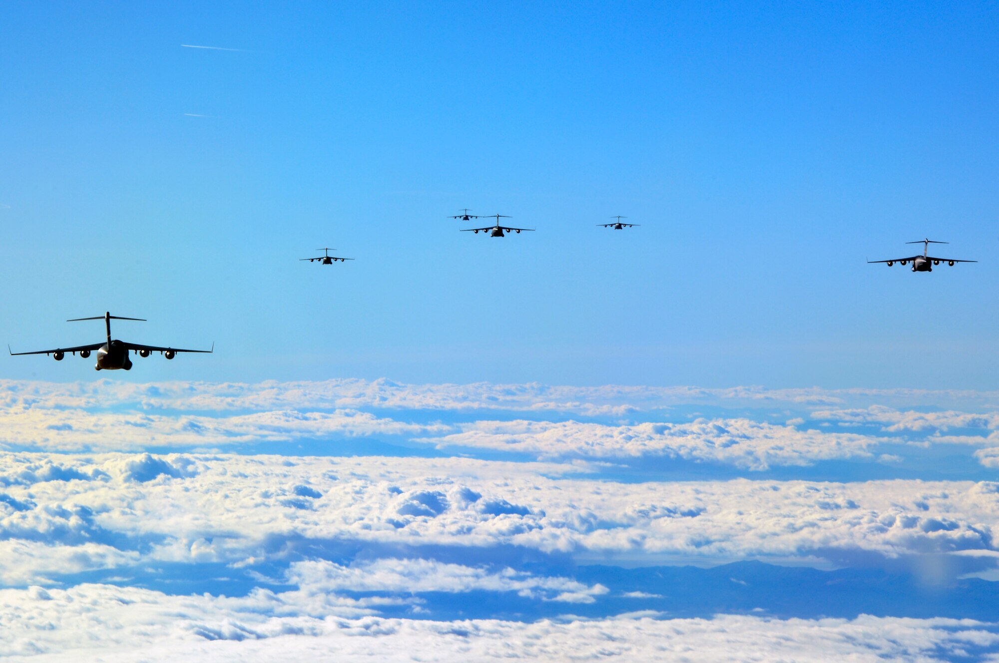 C-17 Globemaster III aircraft from bases across the U.S. begin to form up Dec. 6, 2014, before a joint forcible entry exercise near the Keno drop zone, Nev. The exercise tested the Air Force’s ability to tactically deliver and recover combat assets via air drops in a contested environment. (U.S. Air Force photo/Staff Sgt. Russ Jackson)