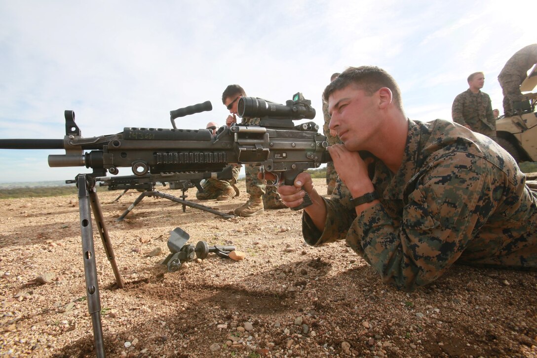 U.S. Marine Corps Cpl. Chase Hawkins with Battalion Landing Team 3rd Battalion, 1st Marine Regiment, 15th Marine Expeditionary Unit calibrates an M249 squad automatic weapon during a realistic urban training exercise aboard Camp Roberts, Calif., Dec. 9, 2014. RUT prepares the 15th MEU's Marines for their upcoming deployment, enhancing their combat skills in environments similar to those they may find in future missions. (U.S. Marine Corps photo by Sgt. Jamean Berry/Released)