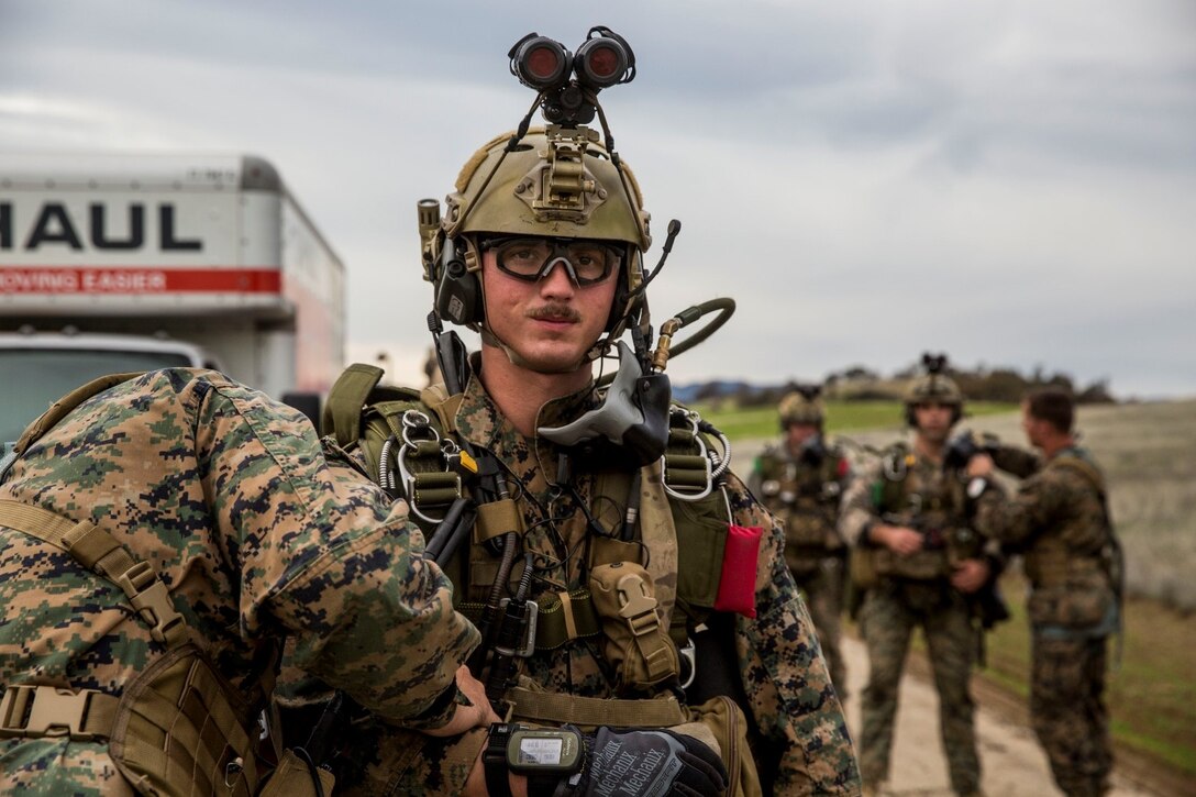 U.S. Marine Sgt. Nathaniel Houck stands while his gear is checked prior to a static-line jump during realistic urban training aboard Fort Hunter Liggett, Calif., Dec. 9, 2014. Houck is part of the 15th Marine Expeditionary Unit’s Force Reconnaissance Detachment. The purpose of RUT is to provide the MEU an opportunity to conduct training in unfamiliar environments in preparation for their upcoming deployment. (U.S. Marine Corps photo by Cpl. Anna Albrecht/Released)