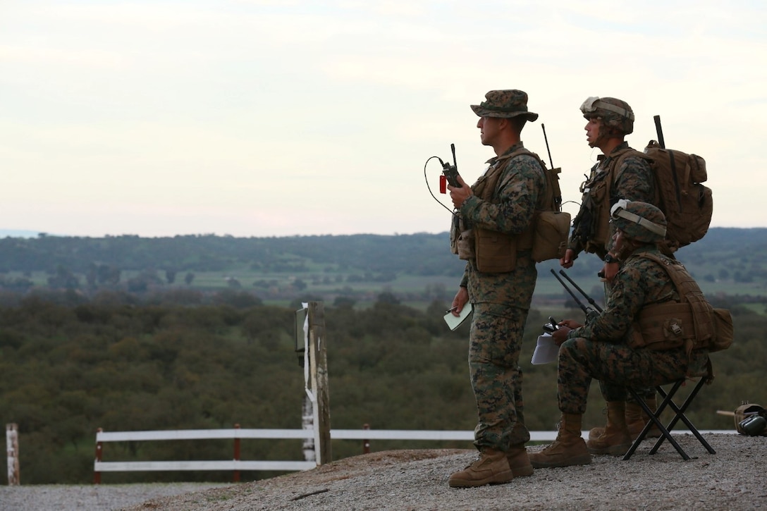 U.S. Marine Corps Capt. Peter Abramovs, Capt. Danny DeVito, Capt. Stephen Miggens, forward air controllers with 15th Marine Expeditionary Unit coordinate air support and indirect fire during a realistic urban training exercise aboard Camp Roberts, Calif., Dec. 9, 2014.  RUT prepares the 15th MEU's Marines for their upcoming deployment, enhancing their combat skills in environments similar to those they may find in future missions. (U.S. Marine Corps photo by Sgt. Jamean Berry/Released)