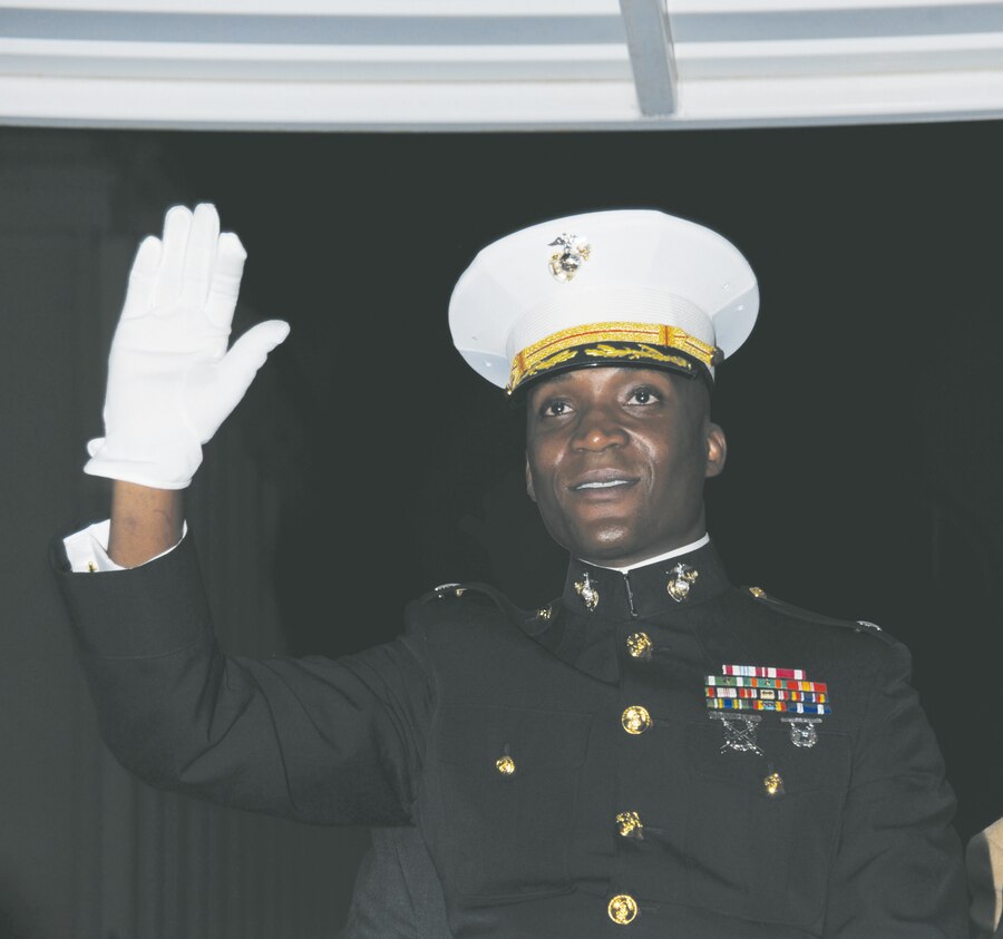 Lt. Col. Nathaniel Robinson, executive officer, Marine Corps Logistics Base Albany, waves to individuals in one of the nearly 70 parade entries during the 24th annual Celebration of Lights parade in downtown Albany, Saturday.