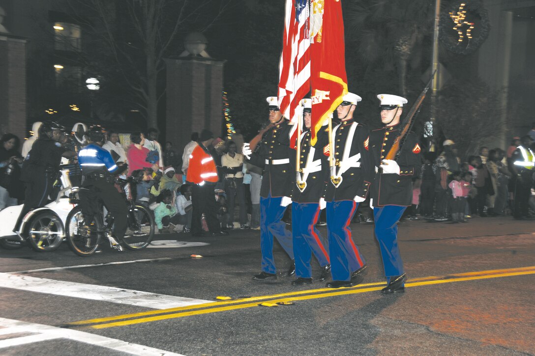 The Marine Corps Logistics Base Albany color guard marches down Pine Avenue in support of the 24th annual Celebration of Lights parade in downtown Albany, Dec. 6.