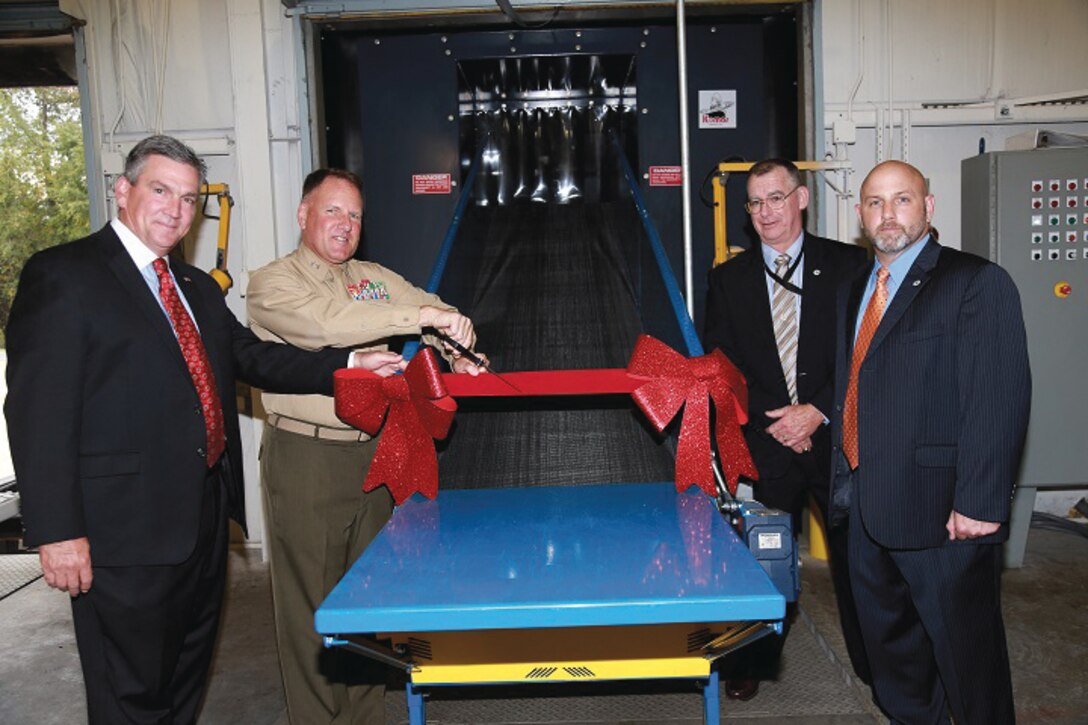 Maj. Gen. John J. Broadmeadow (back left), commanding general, Marine Corps Logistics Command, cuts the ribbon on a new consolidated shredding and disposal facility at Marine Corps Logistics Base Albany, recently. With him are Michael Williamson (front left), director, LOGCOM's Logistics Services Management Center; Robert Wilson (front right), director, Joint Program Office-Chemical Biological Defense Enterprise Fielding and Surveillance; and Bob Cerney (back right), business manager, JEFS.