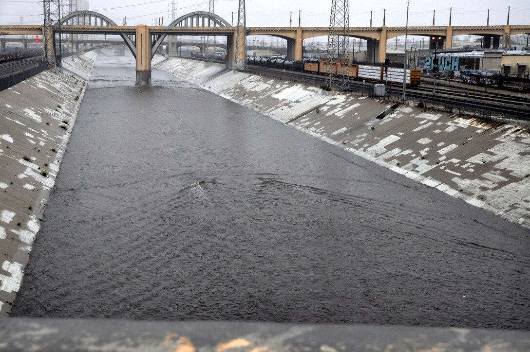 The LA River flows rapidly after passing under the 6th Street bridge at 1 p.m. Dec. 2, 2014. Other areas of the river are narrower and a lot deeper.