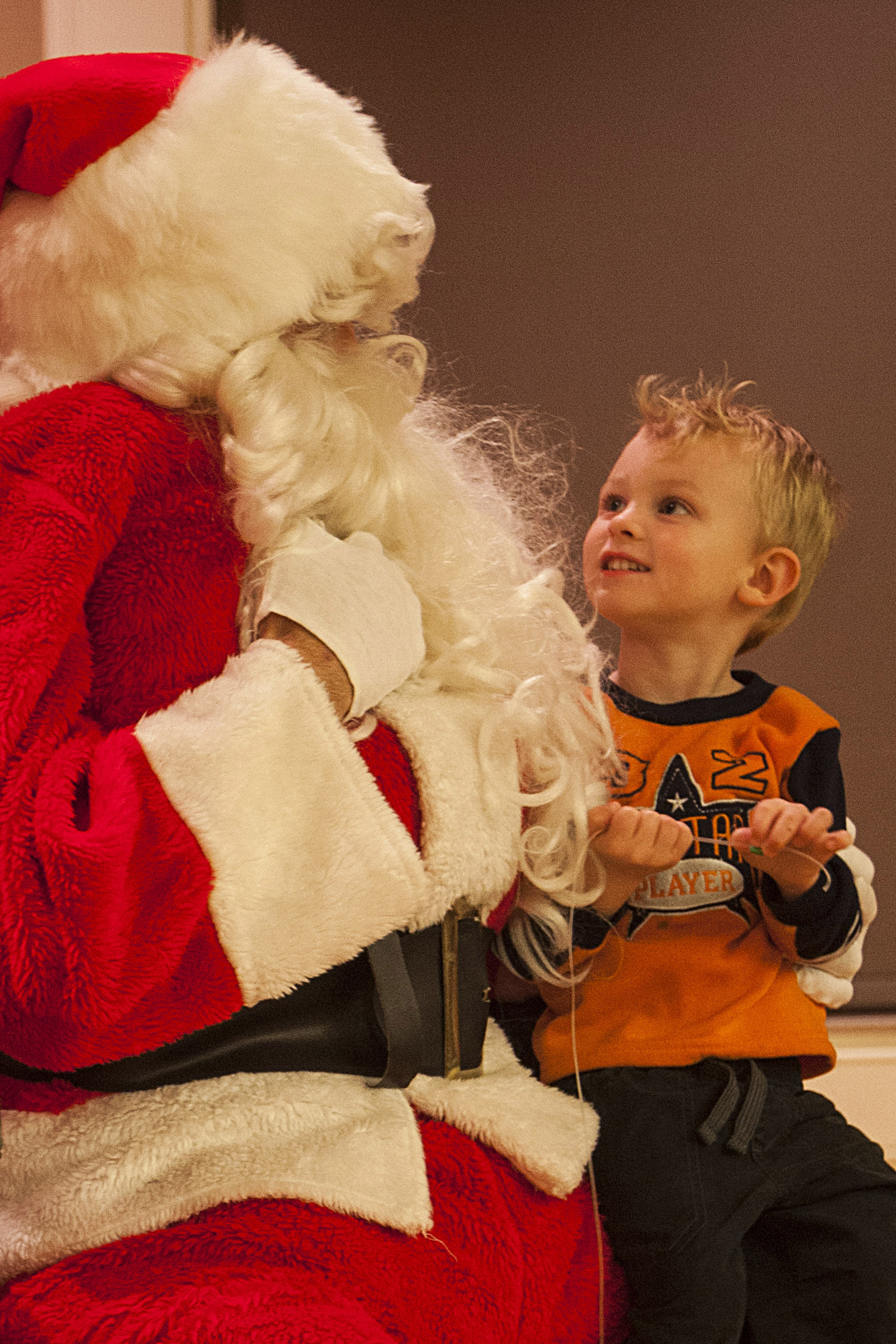 Santa Claus asks a child about his Christmas wishes during the 22nd Marine Expeditionary Unit (MEU) Christmas party Dec. 10, 2014, at Marine Corps Base Camp Lejeune, N.C. (U.S. Marine Corps photo by Sgt. Austin Hazard/Released)