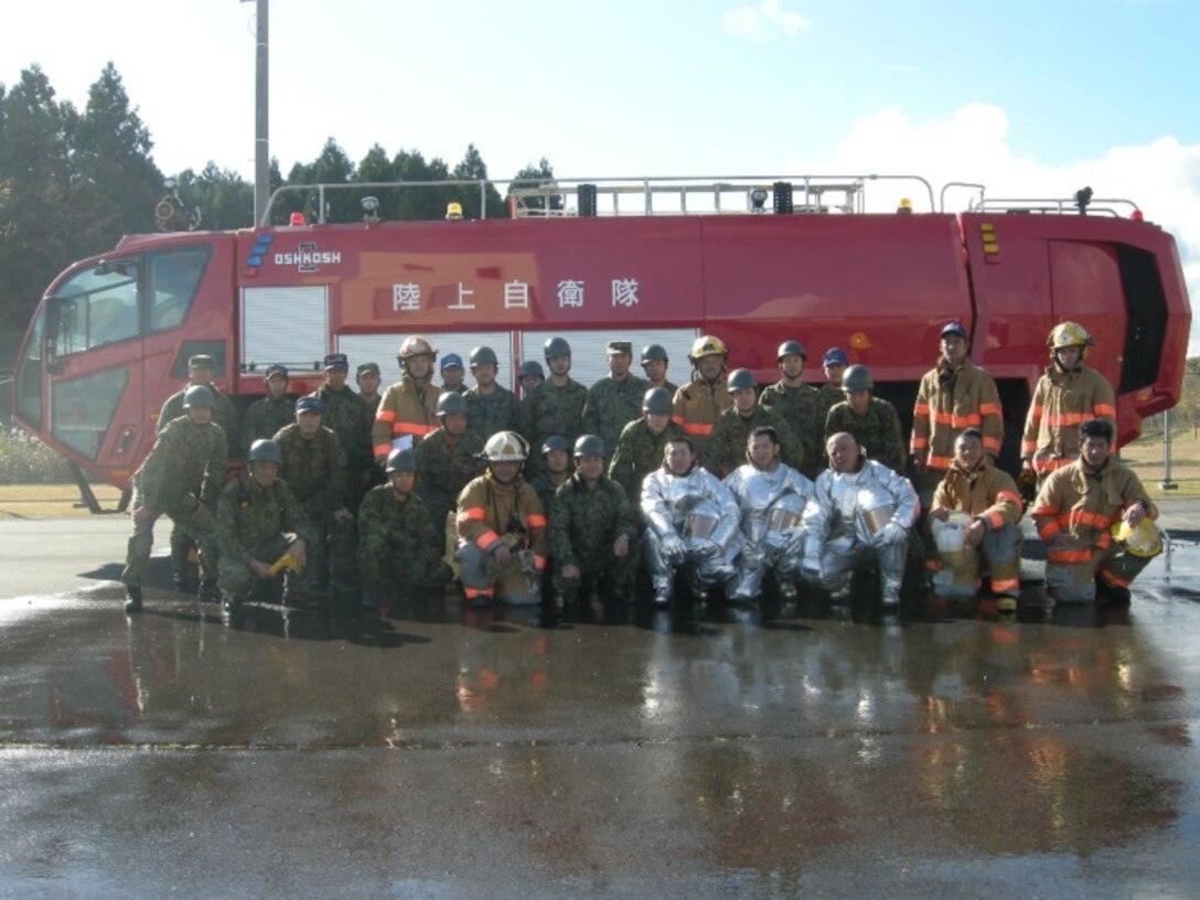 21 Nov 2014, Shizuoka prefecture, Camp Fuji, Japan - Members of the Camp Fuji Fire Department build rapport and increase interoperability by conducting live fire-fighting training and helicopter bucket operation training with members of the Japan Ground Self Defense Force Camp Fuji Aviation Detachment.