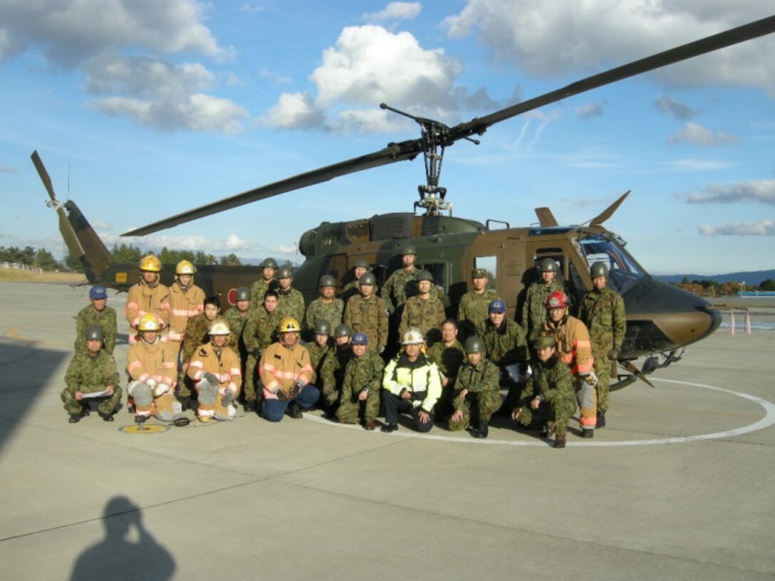 21 Nov 2014, Shizuoka prefecture, Camp Fuji, Japan - Members of the Camp Fuji Fire Department build rapport and increase interoperability by conducting live fire-fighting training and helicopter bucket operation training with members of the Japan Ground Self Defense Force Camp Fuji Aviation Detachment.