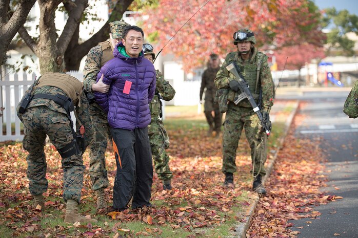 Provost Marshal’s Office Marines and Japan Ground Self-Defense Force troops conducted riot control training in addition to capturing and detaining intruders during Exercise Keen Sword aboard Marine Corps Air Station Iwakuni, Japan, Nov. 18, 2014. Keen Sword is a routine force protection exercise designed to strengthen the relationship and interoperability between the air station and JGSDF forces.