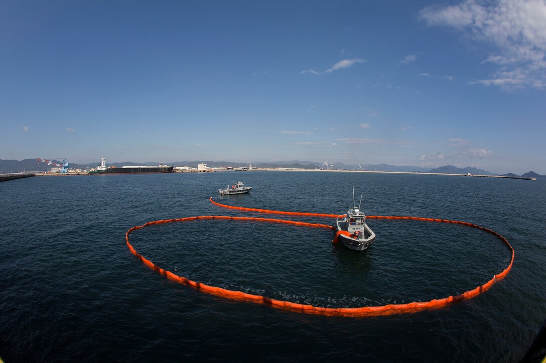 Service members from Marine Corps Air Station Iwakuni practiced the procedures for containing an oil spill during Exercise Keen Sword aboard MCAS Iwakuni, Japan, Nov. 18, 2014. Keen Sword is a routine force protection exercise designed to strengthen the relationship and interoperability between the air station and JGSDF forces.
