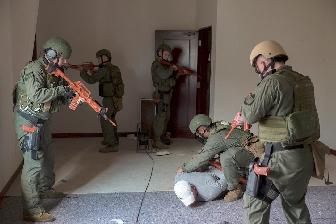 Service members with the Provost Marshal’s Office responded to a hostage situation during Exercise Keen Sword aboard Marine Corps Air Station Iwakuni, Japan, Nov. 17, 2014. Keen Sword is a routine force protection exercise designed to strengthen the relationship and interoperability between the air station and JGSDF forces.
