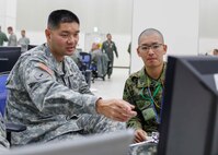 YOKOTA AIR BASE, Japan (Dec. 8, 2014) - A U.S. Army Soldier and Japan Ground Self-Defense Force Soldier prepare for the Yama Sakura 67 exercise. Yama Sakura is an annual bilateral exercise between the U.S. Army and JGSDF that is aimed at increasing combat readiness between the two nations.   