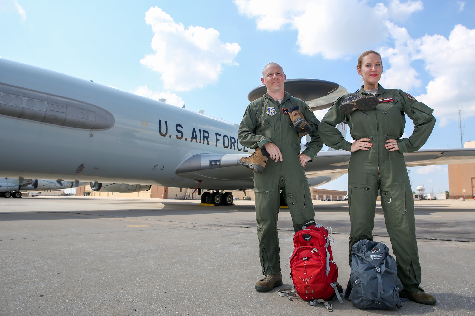 Senior Airman Kelly Higgins, left, and Master Sgt. Amanda Black, both assigned to the 970th Airborne Air Control Squadron at Tinker Air Force Base, Oklahoma, show off their hiking gear August 3 in front of an E-3 Sentry at Tinker. Higgins and Black hiked more than 36 miles during a recent trip to Hawaii. (U.S. Air Force photo/Staff Sgt. Caleb Wanzer)