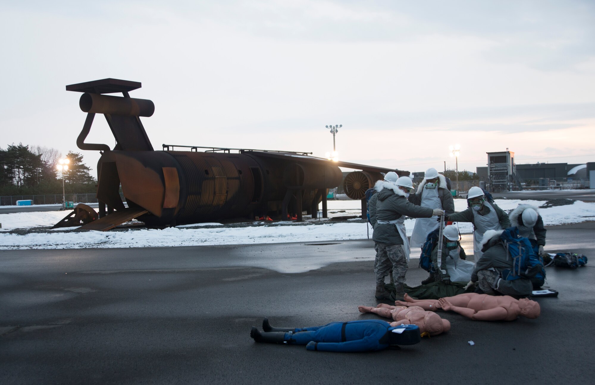 Search and recovery Airmen from the 35th Force Support Squadron examine a simulated body during exercise Beverly Sunrise 15-1 at Misawa Air Base, Japan, Dec. 10, 2014. Emergency personnel assembled after a simulated C-130 Hercules was downed and required multiple agencies to take appropriate response actions. (U.S. Air Force photo by Staff Sgt. Derek VanHorn/Released)