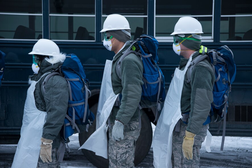 Airmen from the 35th Force Support Squadron arrive at the scene of a simulated aircraft crash at Misawa Air Base, Japan, Dec. 10, 2014. First responders, along with search and recovery teams assembled for an initial brief concerning a simulated C-130 Hercules crashed on base during exercise Beverly Sunrise 15-1. (U.S. Air Force photo by Staff Sgt. Derek VanHorn/Released)