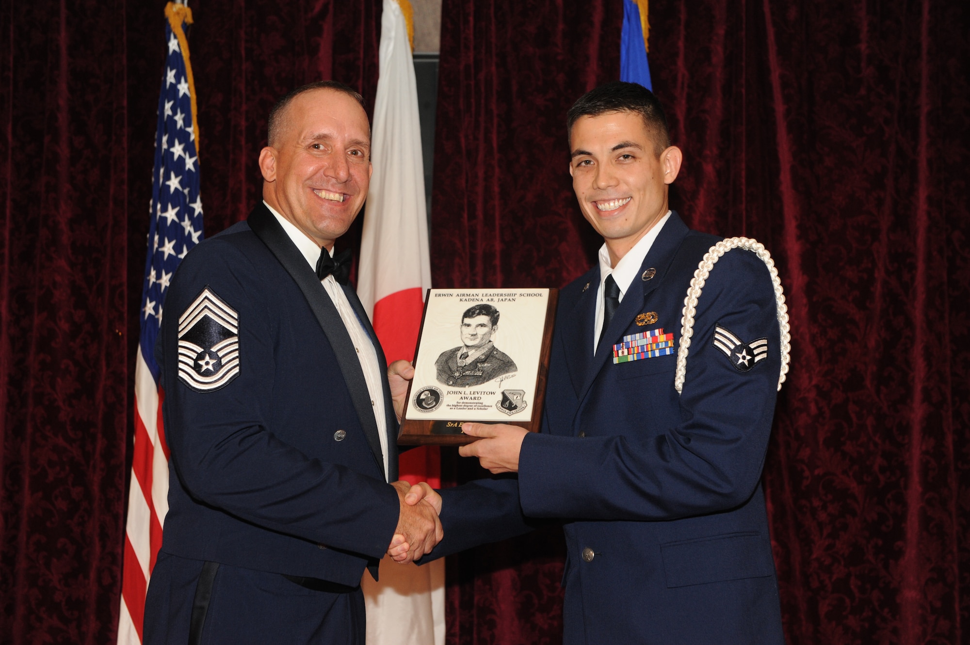 U.S. Air Force Senior Airman Eric Sperry, 718th Aircraft Maintenance Squadron, accepts the John L. Levitow Award during the graduation ceremony for Airman Leadership School class 15-A on Kadena Air Base, Japan, Dec.11, 2014. The John L. Levitow award is presented to the student who earns the highest average score on evaluations and most embodies the Air Force core values. (U.S. Air Force photo by Airman 1st Class Stephen G. Eigel/Released)