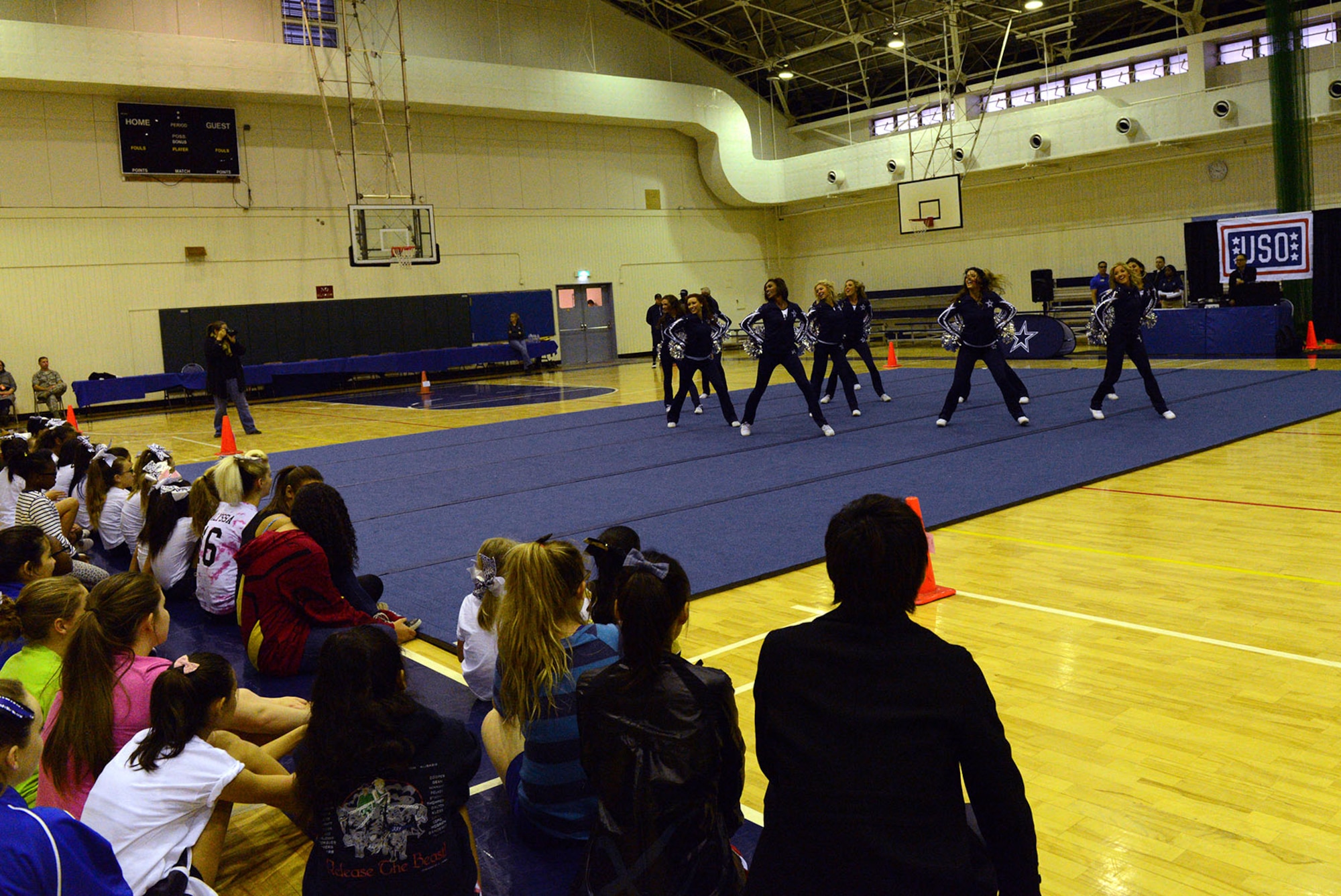 Dallas Cowboys Cheerleaders perform for children and their families at the Samurai Fitness Center Dec. 9, 2014, at Yokota Air Base, Japan. The cheerleaders visited Yokota as part of their USO tour. (U.S. Air Force photo by Senior Airman Desiree Economides/Released)