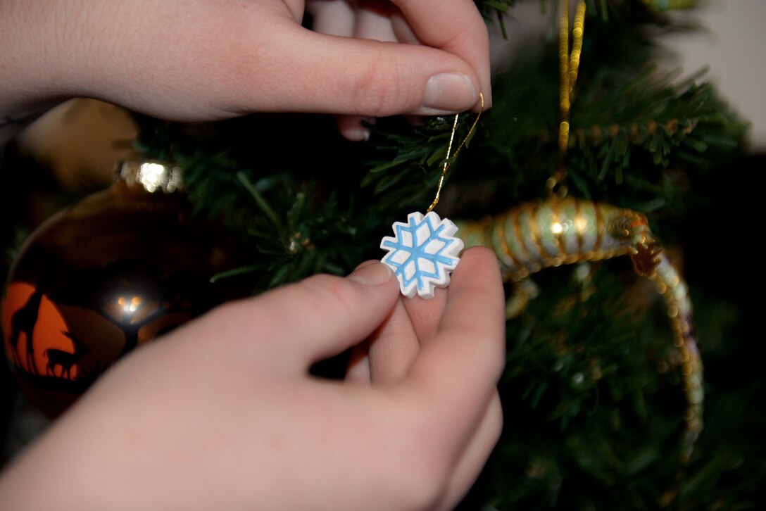 Senior Airman Lucille Perkins-Wagel, 28th Force Support Squadron services technician, decorates a Christmas tree in her dorm room at Ellsworth Air Force Base, S.D., Dec. 4, 2014. Every year, throughout the holiday seasons Perkins-Wagel decorates her dorm to keep the holiday spirit alive and to give her room a home-like feeling. (U.S. Air Force Photo by Airman 1st Class Rebecca Imwalle/Released)