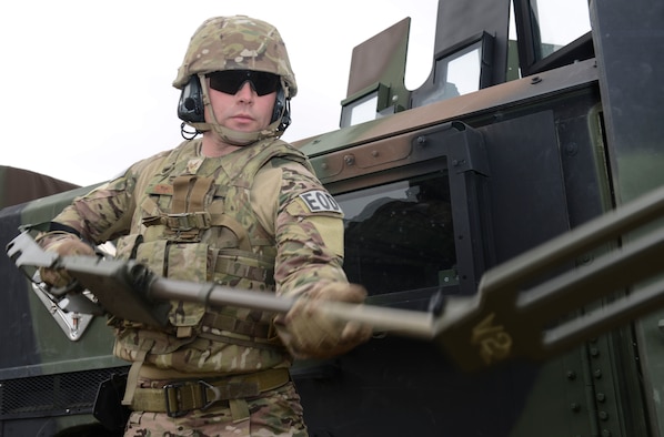 Senior Airman Richard Bezouska, 366th Civil Engineering Squadron explosive ordinance disposal journeyman, unloads gear during a training event Dec. 10, 2014, at Mountain Home Air Force Base, Idaho. Bezouska demonstrated how EOD gear is loaded for deployments and how the new system for loading and unloading is more effective. (U.S. Air Force photo by Airman 1st Class Malissa Lott/RELEASED)