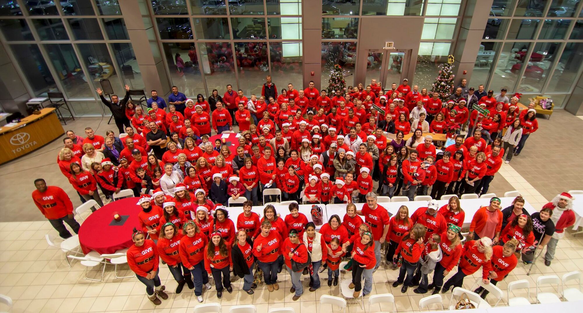 Participants of the Big Give Christmas Edition 2014 pose for a group photo at Desert Suns Motors in Alamogordo, N.M., Dec. 9. The BGCE is an annual event hosted by the community, in which teams dedicate their time, money and efforts to give back to the families in need during the holidays season. (Courtesy Photo.)