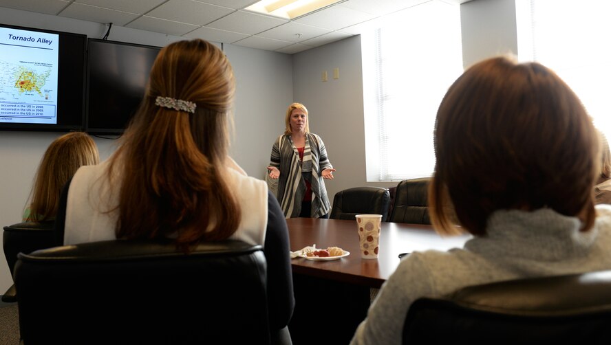 Claire Alexander, Key Spouse Program mentor, leads an orientation for spouses of 26th Operational Weather Squadron first-term Airmen on Barksdale Air Force Base, La., Dec. 9, 2014. The Key Spouse Program is an organization of appointed, volunteer spouses helping other spouses. It is a formal unit program which offers peer-to-peer support to families. (U.S. Air Force photo/Airman 1st Class Curt Beach)