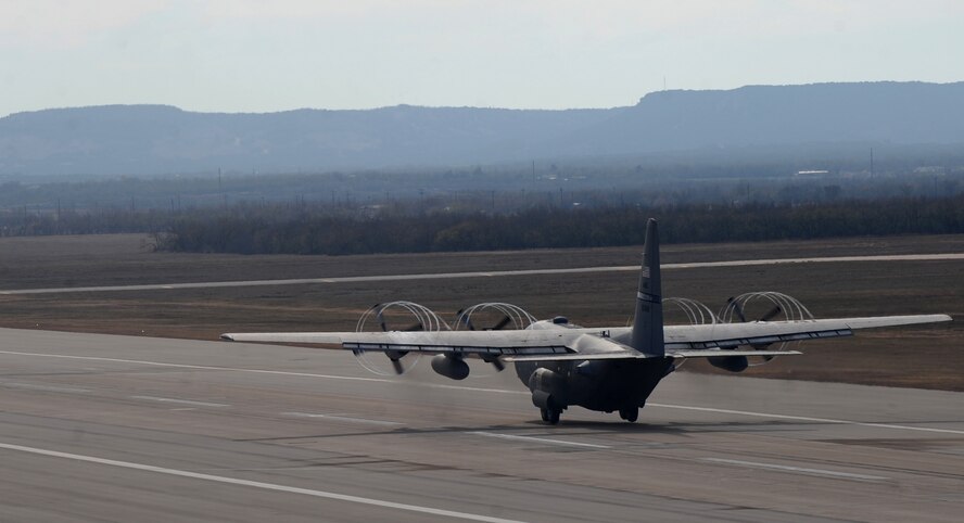 A C-130H takes off Dec. 6, 2014, at Dyess Air Force Base, Texas. The mixed units of C-130Js and H models were headed to Nellis Air Force Base, Nev., in support of a joint forcible entry exercise. (U.S. Air Force photo by Airman 1st Class Alexander Guerrero/Released)