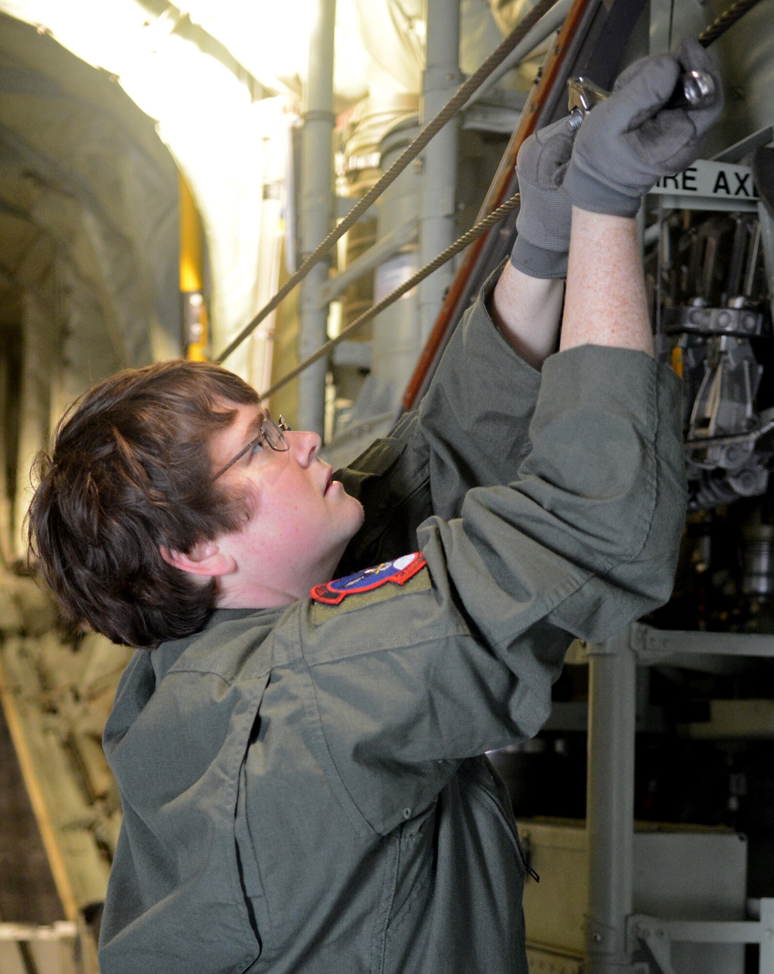 U.S. Air Force Staff Sgt. Elizabeth Patton, 317th Operation Support Squadron loadmaster, prepares a static line before a joint forcible entry exercise Dec. 6, 2014, at Dyess Air Force Base, Texas. During the exercise, Patton and other loadmasters were responsible for ensuring the safe extraction of U.S. Army Soldiers from their aircraft. (U.S. Air Force photo by Airman 1st Class Autumn Velez/Released)