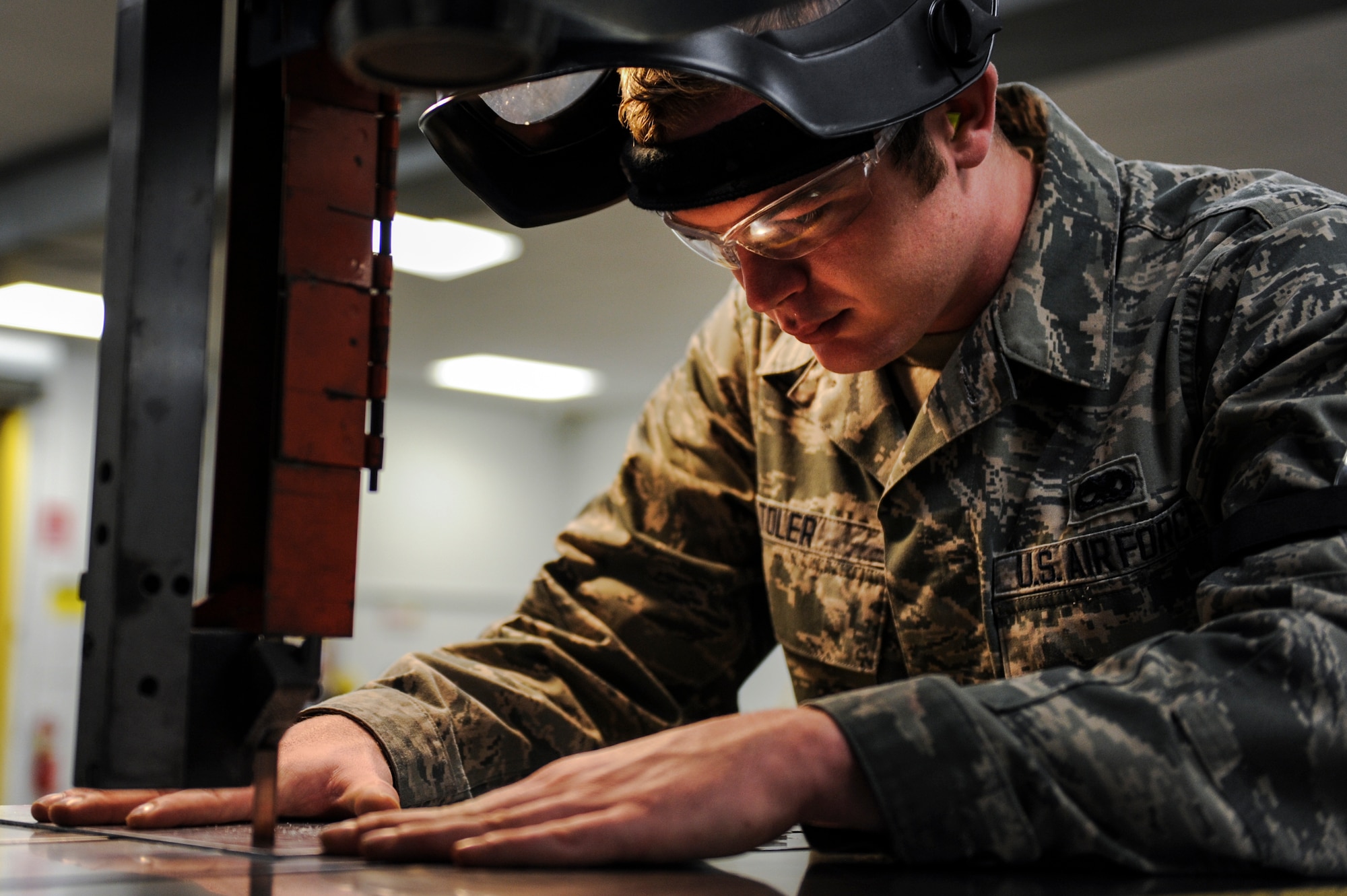 Airman 1st Class Charles Toler, a 19th Maintenance Squadron aircraft structural maintainer, lines up a cut on a DoAll saw Nov. 25, 2014, at Little Rock Air Force Base, Ark. A DoAll saw is a vertical band saw, used specifically for cutting metals. (U.S. Air Force photo by Senior Airman Cliffton Dolezal)  
