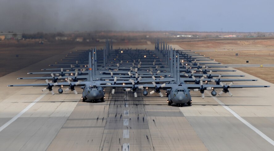 Eleven C-130H Hercules’ from various Air National Guard units and thirteen C-130J Super Hercules’ from the 317th Airlift Group at Dyess Air Force Base, Texas, prepare to take off from Dyess AFB in support of the U.S. Air Force Weapons School's Joint Forcible Entry Exercise 14B Dec. 6, 2014. In addition to the C-130s, the JFEX included approximately 20 C-17 Globemaster IIIs and various other aircraft. (U.S. Air Force photo by Airman 1st Class Alexander Guerrero/Released)