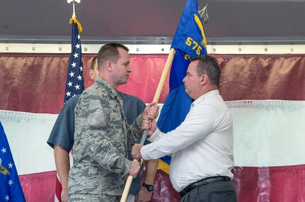 Brig. Gen. Carl Buhler, Ogden Air Logistics Complex commander, passes the guidon to  Robert A. Lewis, 575th Aircraft Maintenance Squadron director, the 575th Aircraft Maintenance Squadron guidon as part of the 575th AMXS activation ceremony Dec. 11 at Joint Base San Antonio-Randolph. The 575th AMXS is a geographically separate unit assigned to the 309th Aircraft Maintenance Group, Ogden Air Logistics Complex Hill Air Force Base, Utah. The squadron is responsible for depot level maintenance, restoration and modification of over 500 T-38 Talon aircraft for the United States Air Force and Navy. (U.S. Air Force photo by Johnny Saldivar)