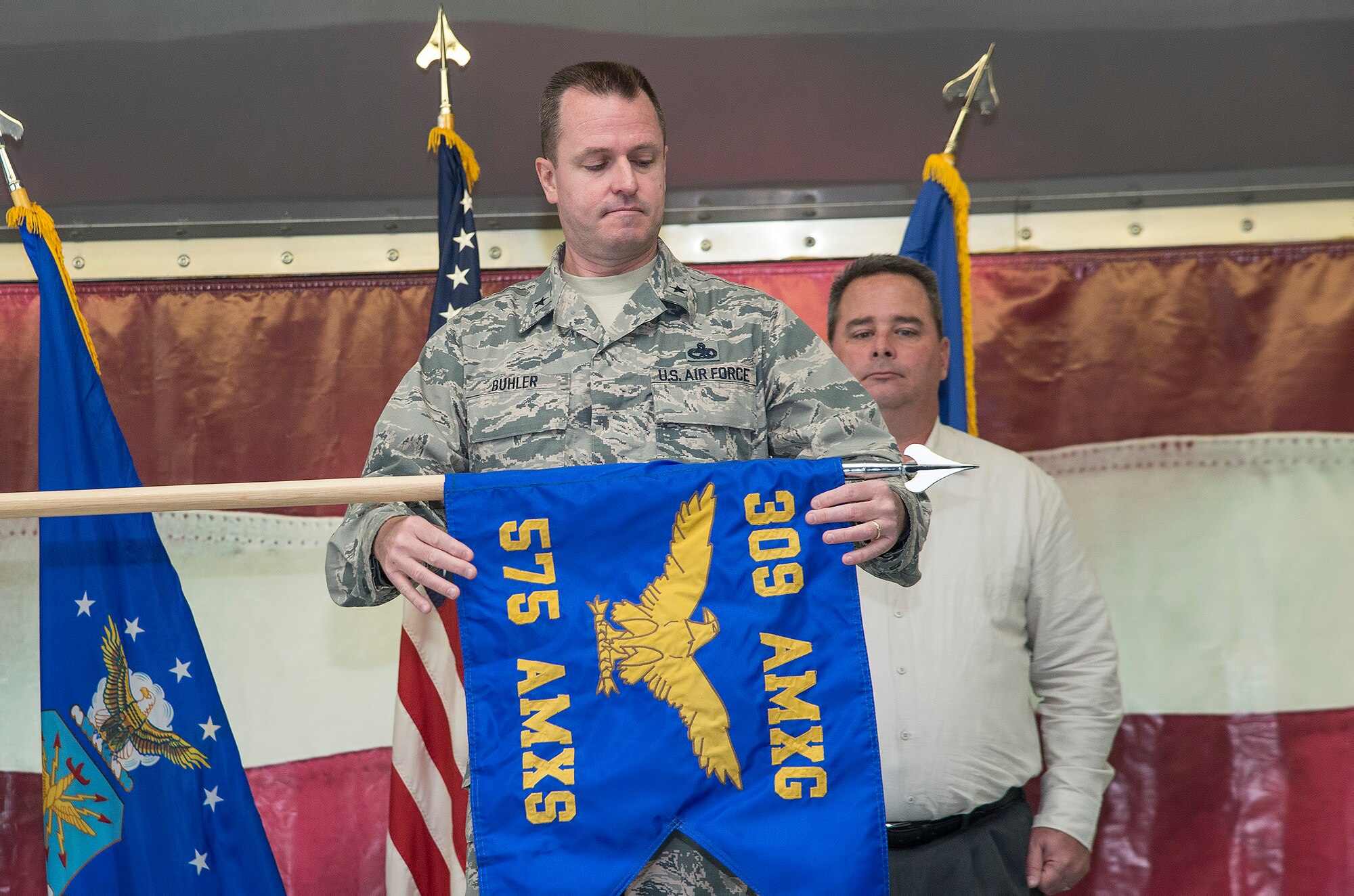 Brig. Gen. Carl Buhler, Ogden Air Logistics Complex commander, unfurls the 575th Aircraft Maintenance Squadron guidon as part of the 575th AMXS activation ceremony Dec. 11 at Joint Base San Antonio-Randolph. The 575th AMXS is a geographically separate unit assigned to the 309th Aircraft Maintenance Group, Ogden Air Logistics Complex Hill Air Force Base, Utah. The squadron is responsible for depot level maintenance, restoration and modification of over 500 T-38 Talon aircraft for the United States Air Force and Navy. (U.S. Air Force photo by Johnny Saldivar)