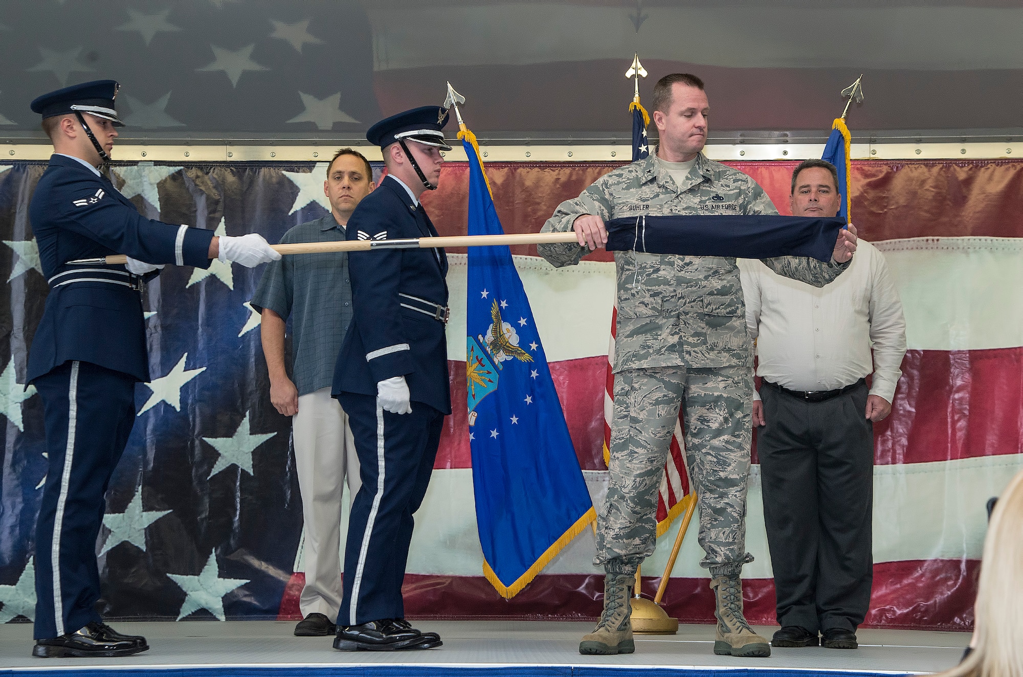 Brig. Gen. Carl Buhler, Ogden Air Logistics Complex commander, unfurls the 575th Aircraft Maintenance Squadron guidon as part of the 575th AMXS activation ceremony Dec. 11 at Joint Base San Antonio-Randolph. The 575th AMXS is a geographically separate unit assigned to the 309th Aircraft Maintenance Group, Ogden Air Logistics Complex Hill Air Force Base, Utah. The squadron is responsible for depot level maintenance, restoration and modification of over 500 T-38 Talon aircraft for the United States Air Force and Navy. (U.S. Air Force photo by Johnny Saldivar)