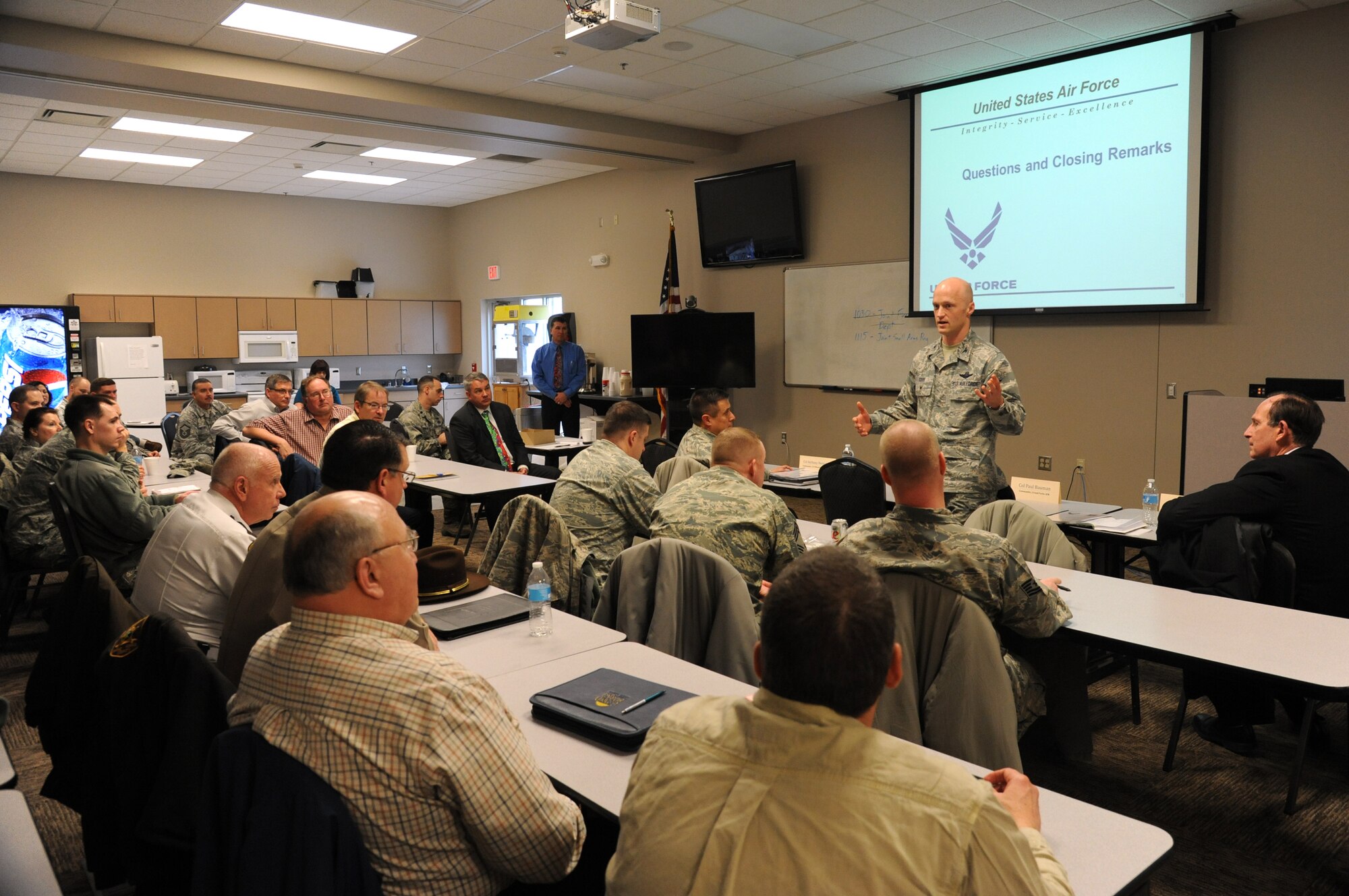 Col. Robert Cook, 319th Air Base Wing vice commander, offers closing remarks at the Air Force Community Partnership Program tabletop exercise at the Public Safety Center in Grand Forks, N.D., Dec. 10, 2014. The exercise brought together Airmen and local civilian officials to work on and finalize projects that will build links between the military and civil populations. (U.S. Air Force photo/Staff Sgt. David Dobrydney)