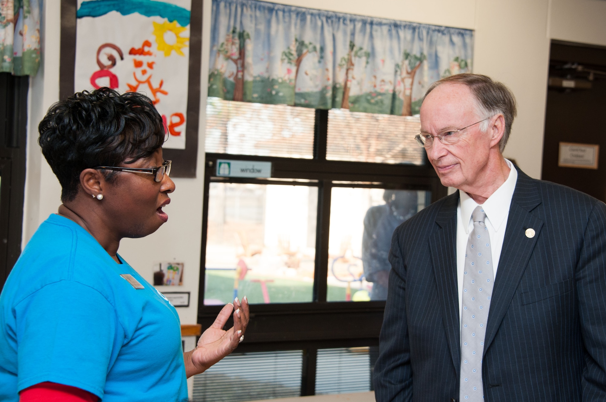 Alabama Governor Robert Bentley speaks with Mary Smith, Gunter Child Development Center child and youth program assistant, Dec. 10.  The governor visited the CDC to highlight Alabama’s First Class Voluntary Pre-Kindergarten Program.  Bentley announced a $17.5 million federal grant to Alabama to support Alabama communities in providing high-quality preschool programs.  A portion of those funds will support the CDCs at both Maxwell and Gunter.  The funds will be used to help pay teachers, facilitate field trips and improve playground equipment. (Air Force Photo by Henry Hancock/Cleared)
